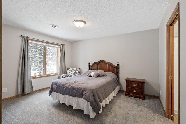 carpeted bedroom with a textured ceiling