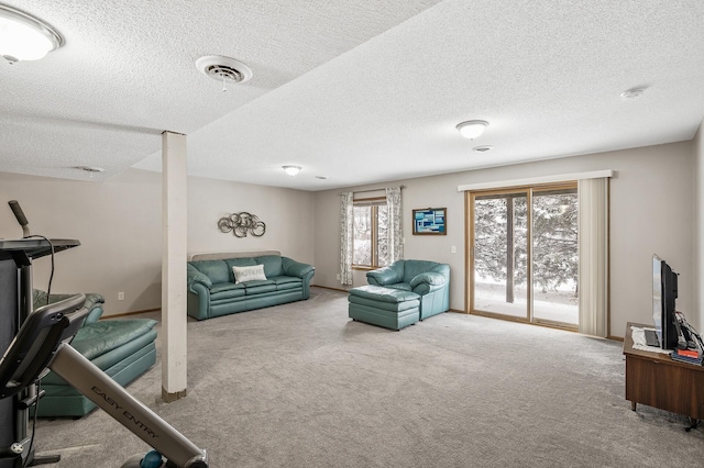 carpeted living room featuring a textured ceiling