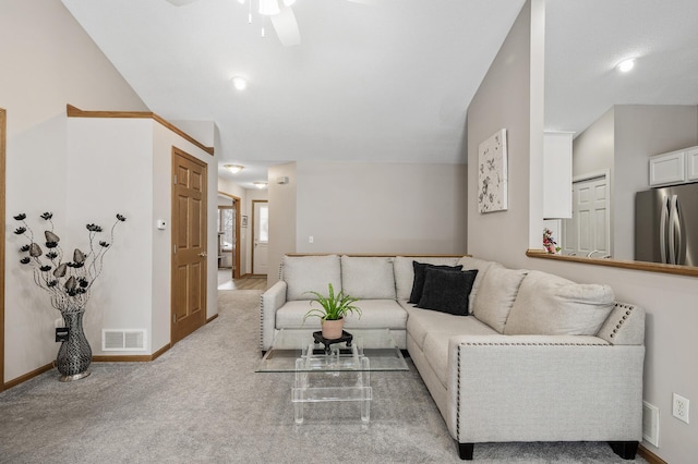 living room with vaulted ceiling, light colored carpet, and ceiling fan