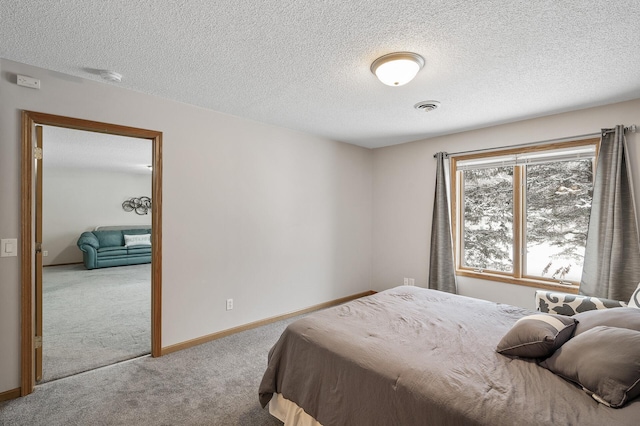 bedroom featuring carpet floors and a textured ceiling