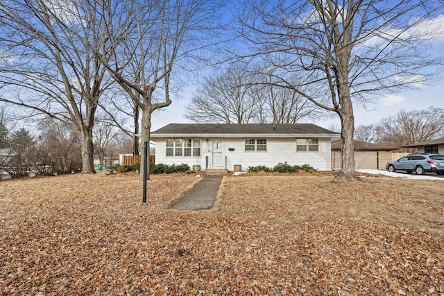 single story home featuring fence