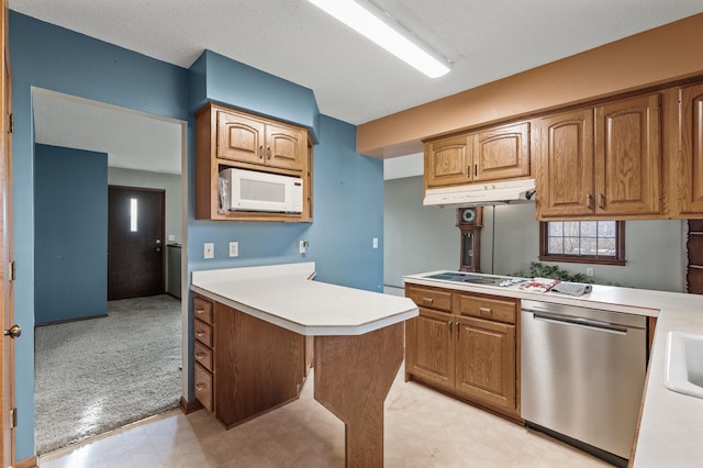 kitchen featuring white appliances, light floors, under cabinet range hood, and light countertops