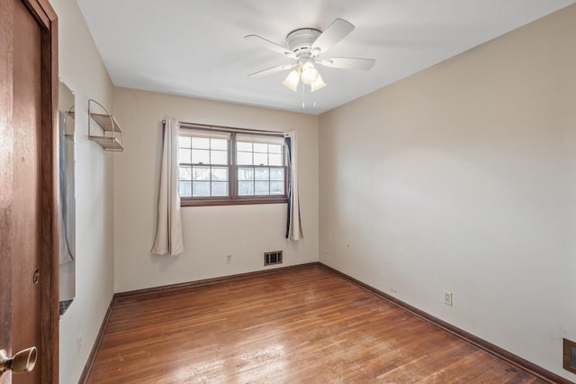 empty room with light wood-type flooring, baseboards, visible vents, and a ceiling fan