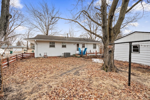 back of house featuring cooling unit and fence