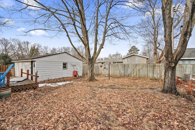 view of yard with fence and a wooden deck