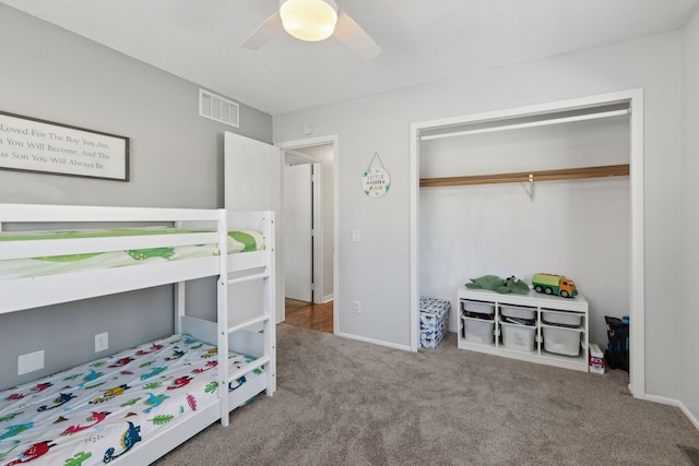 bedroom with ceiling fan, carpet flooring, and a closet