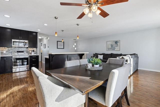 dining space with ceiling fan and dark wood-type flooring