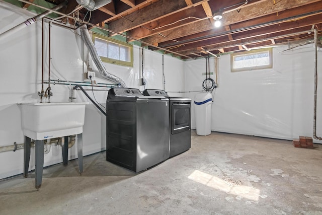 clothes washing area featuring washing machine and dryer and laundry area