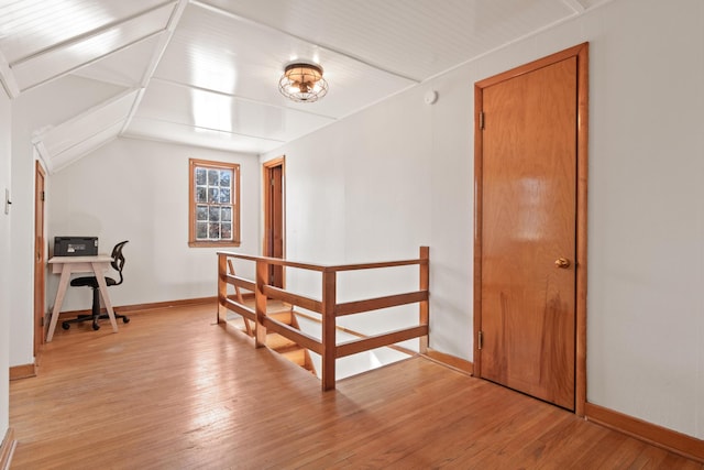 bonus room featuring light wood-style floors and baseboards