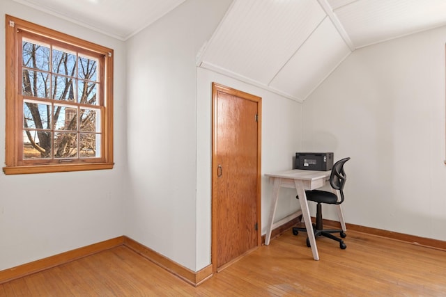 office space with lofted ceiling, light wood-style flooring, and baseboards