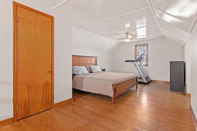 bedroom featuring lofted ceiling, ceiling fan, baseboards, and wood finished floors