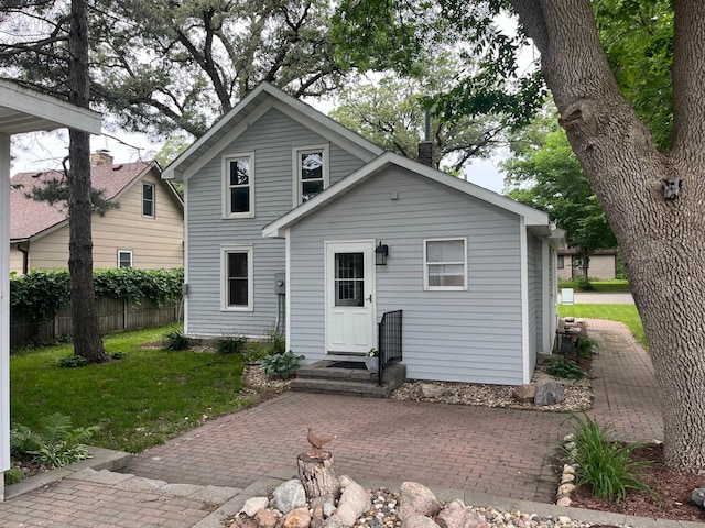 rear view of house with a yard