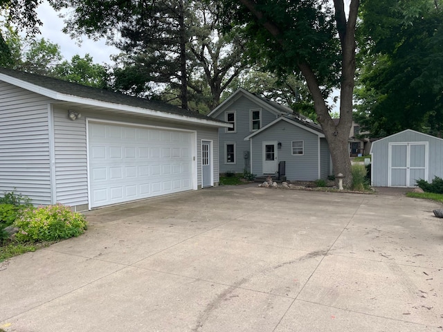 view of front facade with a garage and a shed