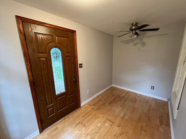 foyer with ceiling fan and light wood-type flooring