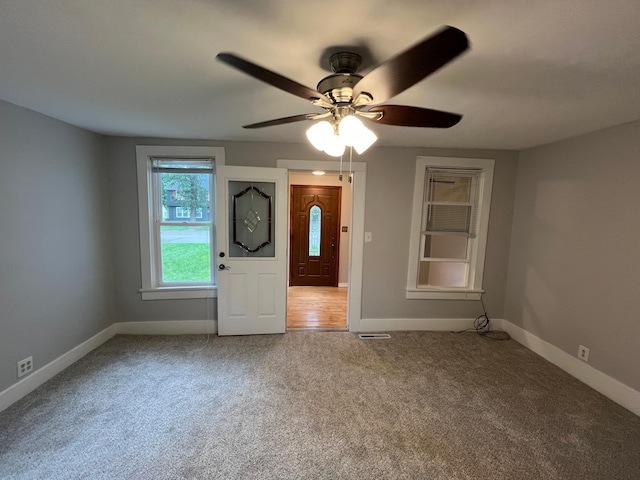 foyer featuring carpet flooring and ceiling fan