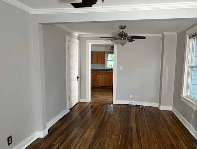 unfurnished room featuring dark hardwood / wood-style flooring, sink, crown molding, and ceiling fan