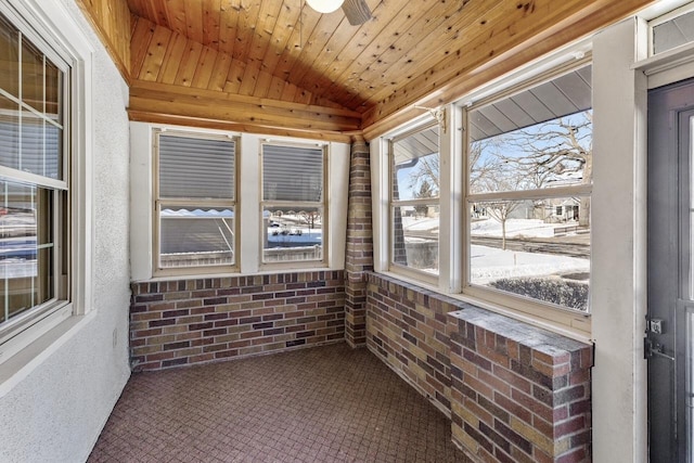 sunroom with vaulted ceiling, ceiling fan, and wood ceiling