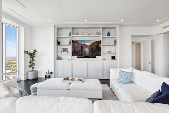 living room with built in shelves and wood-type flooring