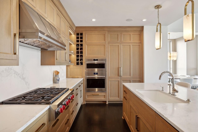 kitchen with sink, stainless steel appliances, dark hardwood / wood-style flooring, decorative light fixtures, and custom exhaust hood