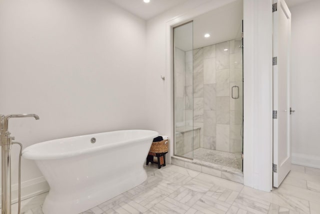 bathroom featuring shower with separate bathtub