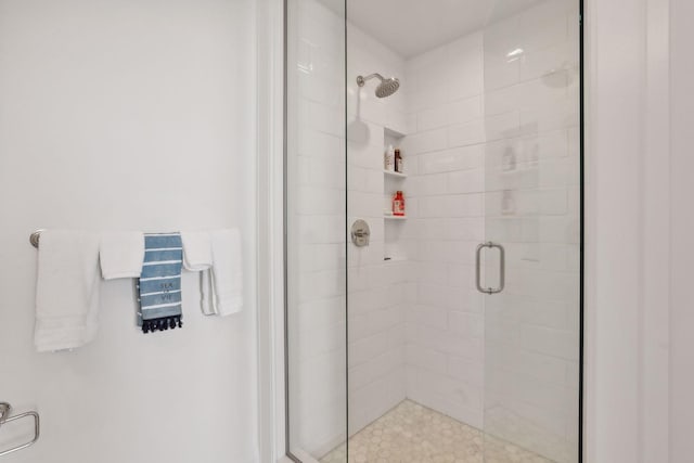 bathroom with a shower with shower door