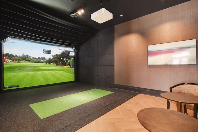 game room with golf simulator and parquet floors