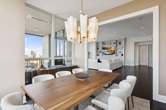 dining room featuring a notable chandelier and dark hardwood / wood-style flooring