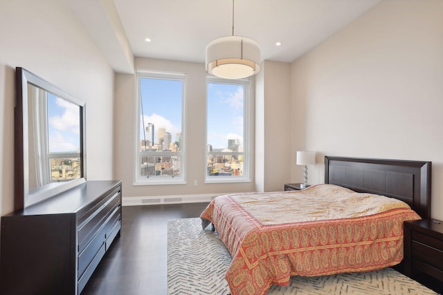 bedroom with dark hardwood / wood-style floors