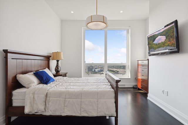 bedroom with dark hardwood / wood-style flooring