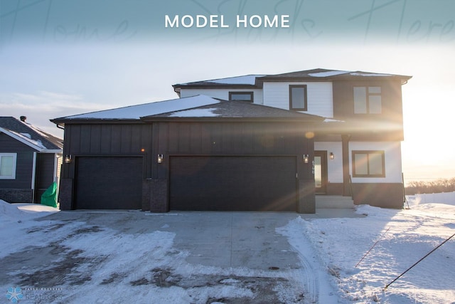 view of front of home with concrete driveway, board and batten siding, and an attached garage