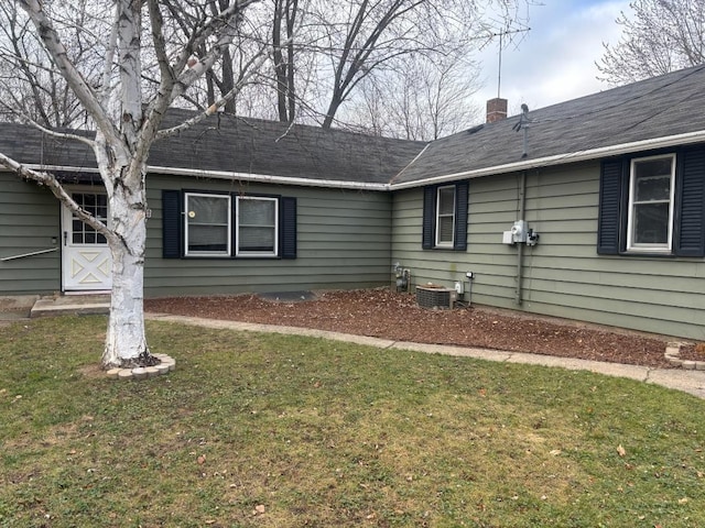 exterior space with a lawn and a chimney