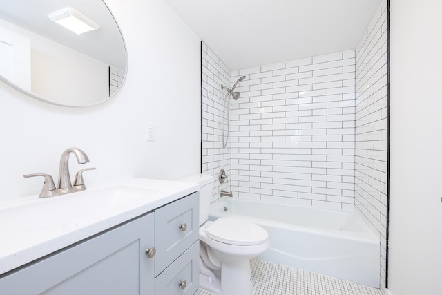 full bathroom with tile patterned flooring, vanity, tiled shower / bath combo, and toilet