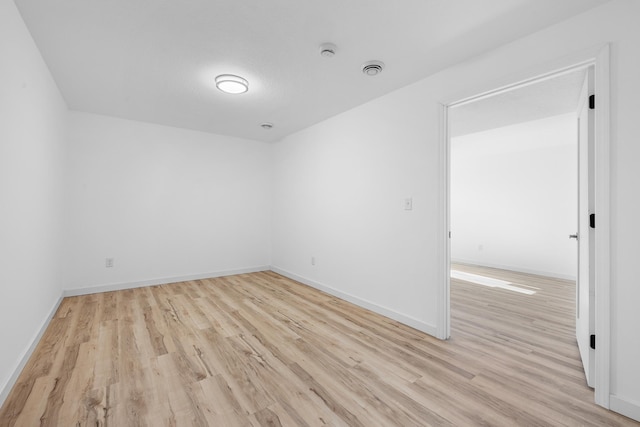 spare room featuring light wood-type flooring