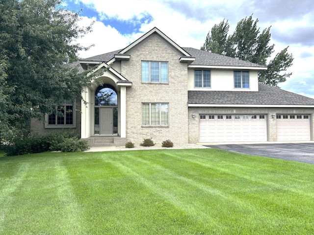 view of front of property featuring a garage and a front lawn