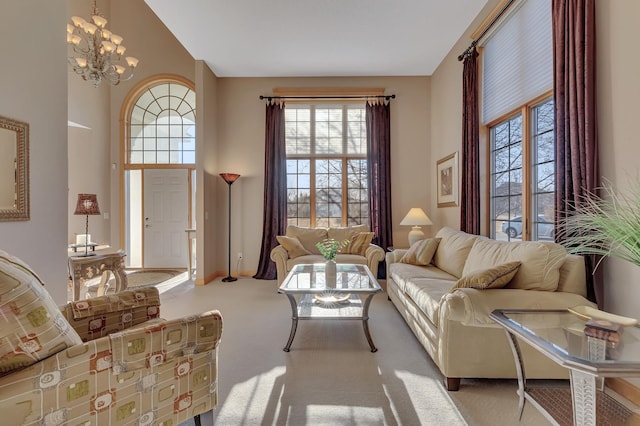 living room featuring light colored carpet, a high ceiling, and a notable chandelier