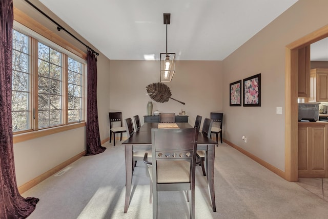 dining room featuring light colored carpet