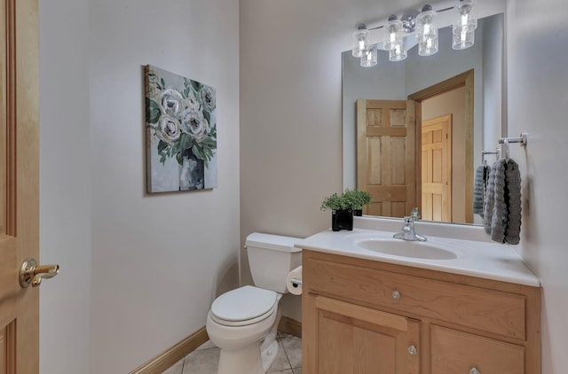 bathroom featuring tile patterned flooring, vanity, and toilet