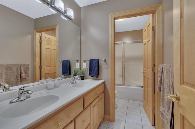 full bathroom with enclosed tub / shower combo, tile patterned floors, toilet, and vanity