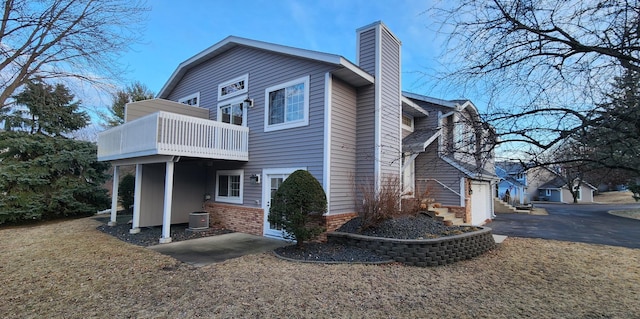 view of side of home featuring a balcony