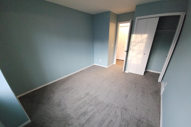 unfurnished bedroom featuring a closet and carpet flooring