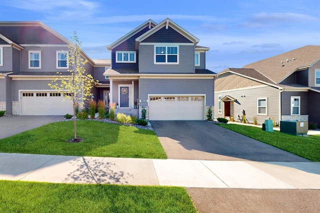 craftsman inspired home with a garage and a front lawn