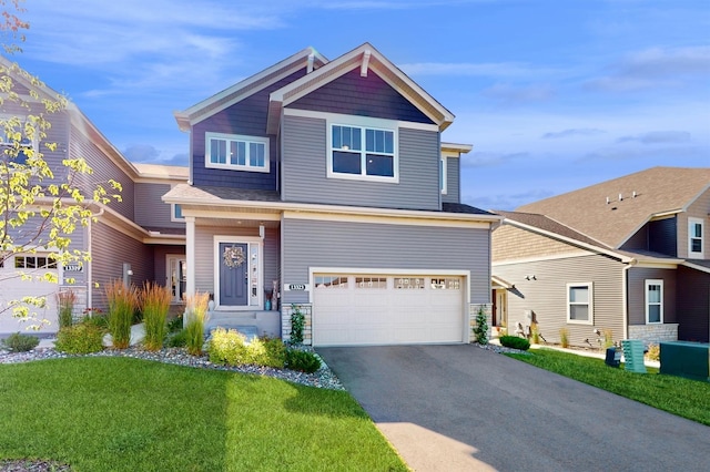 craftsman-style house featuring a garage and a front lawn