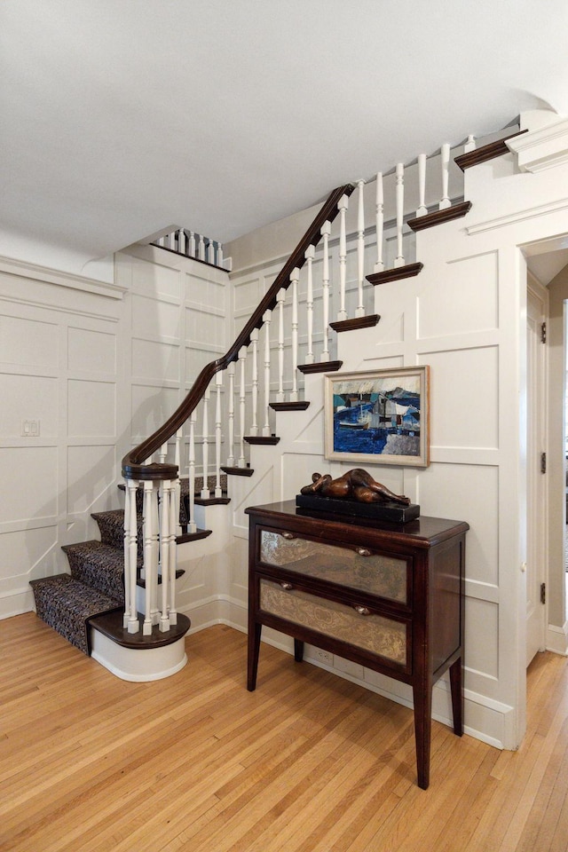 5231 Clinton Ave, Minneapolis, MN 55419 - stairs featuring baseboards, wood finished floors, and a decorative wall