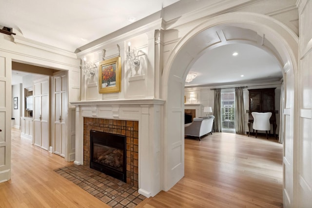 5231 Clinton Ave, Minneapolis, MN 55419 - unfurnished living room with light wood-type flooring, ornamental molding, a decorative wall, and a tile fireplace