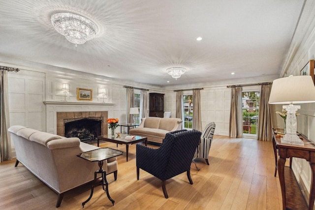 5231 Clinton Ave, Minneapolis, MN 55419 - living area featuring an inviting chandelier, recessed lighting, a tiled fireplace, and light wood-type flooring