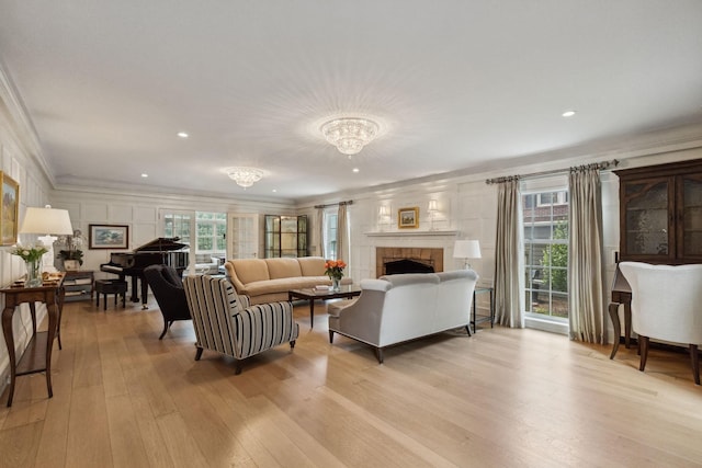 5231 Clinton Ave, Minneapolis, MN 55419 - living room with crown molding, a notable chandelier, a fireplace, light wood-style flooring, and recessed lighting