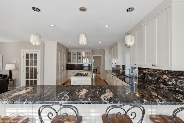 5231 Clinton Ave, Minneapolis, MN 55419 - kitchen featuring stainless steel gas cooktop, decorative backsplash, a sink, and dark stone countertops
