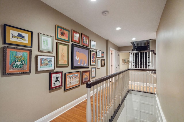 5231 Clinton Ave, Minneapolis, MN 55419 - hall with baseboards, recessed lighting, wood finished floors, and an upstairs landing