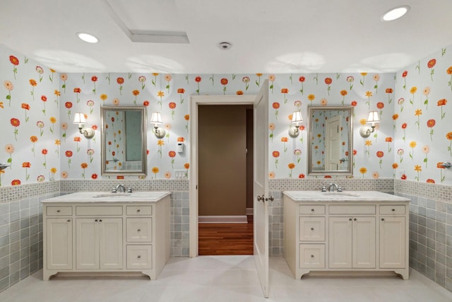 5231 Clinton Ave, Minneapolis, MN 55419 - bathroom featuring wainscoting, wallpapered walls, tile walls, and two vanities