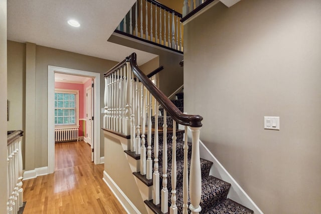 5231 Clinton Ave, Minneapolis, MN 55419 - stairway featuring baseboards, recessed lighting, wood finished floors, and radiator